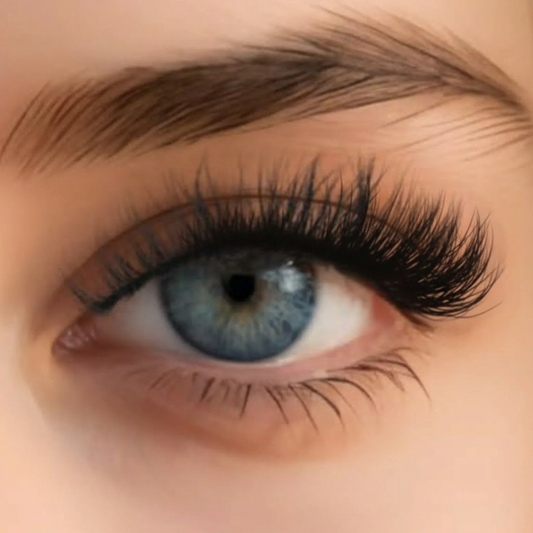 Woman wearing Soft Spoken faux mink lashes with natural makeup and blue eyes