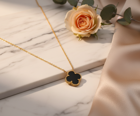 Luxurious gold clover necklace on elegant background